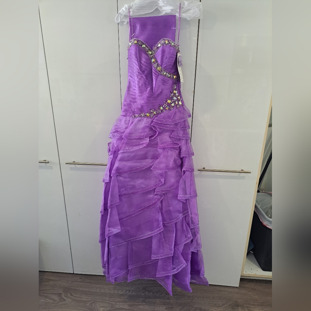 Brand new purple formal prom dress. Would make a fun Barbie or Princess Costume.